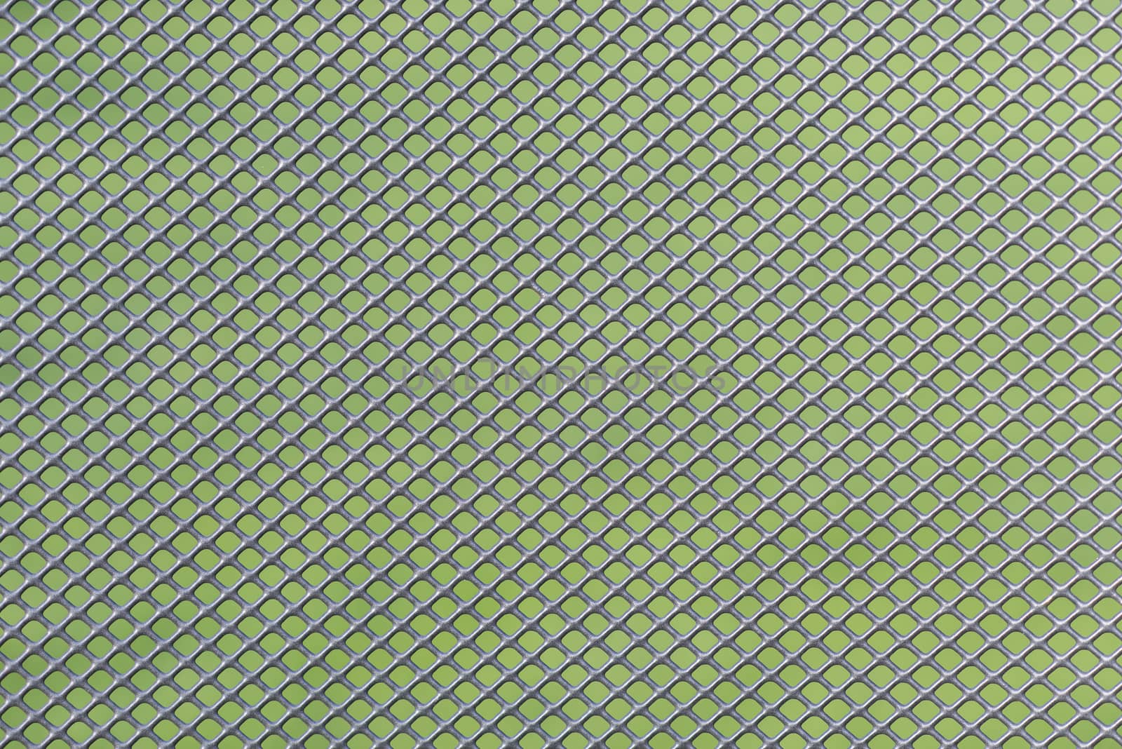 Grey metal wire mesh work against a green background
 by Tofotografie