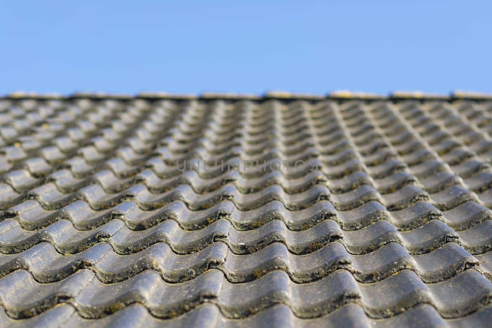 Roof hung with gray concrete roof tiles as background picture
