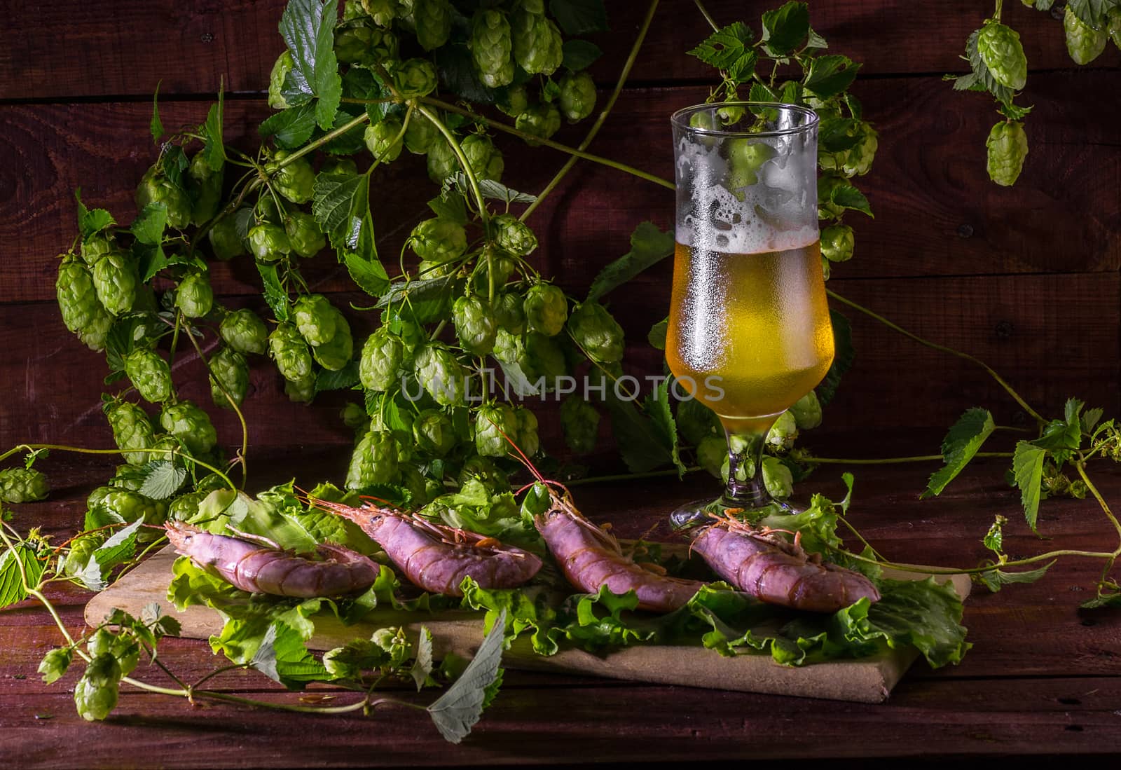 still life with Beer, shrimps and salad on a wooden table