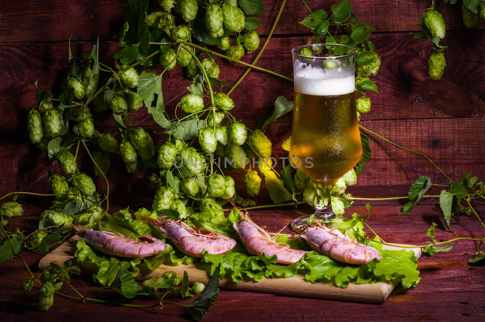 still life with Beer, shrimps and salad on a wooden table