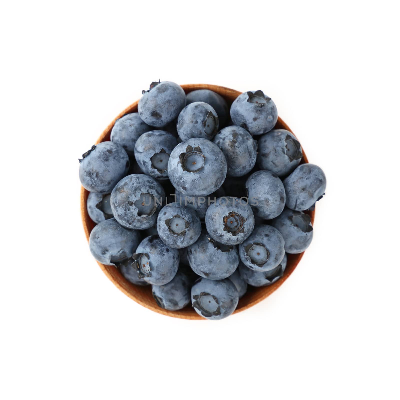 Portion of fresh blueberry berries in rustic wooden bowl isolated on white background, close up, elevated top view, directly above