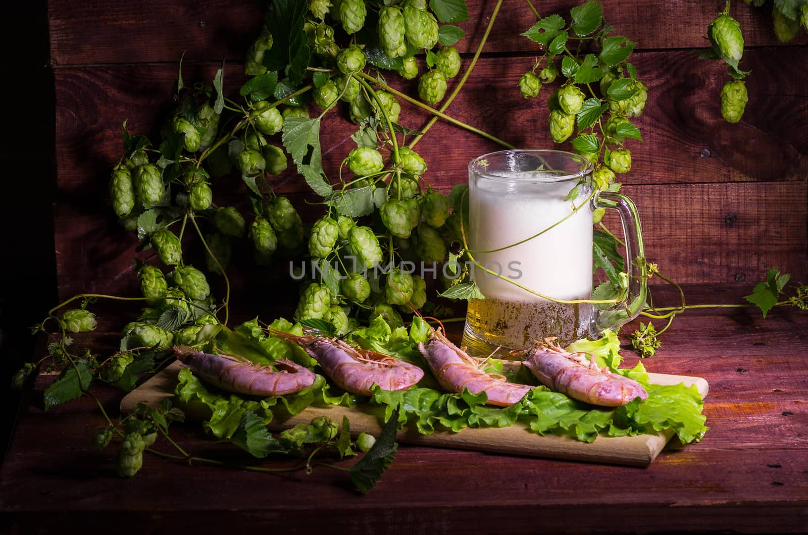 still life with Beer, shrimps and salad on a wooden table