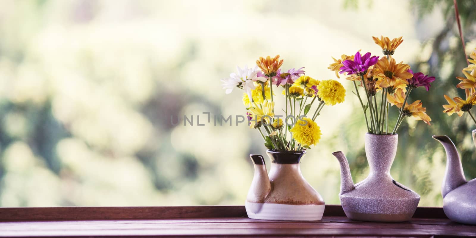 vintage photo of flowers in ceramic potted on bokeh for backgrou by rakoptonLPN