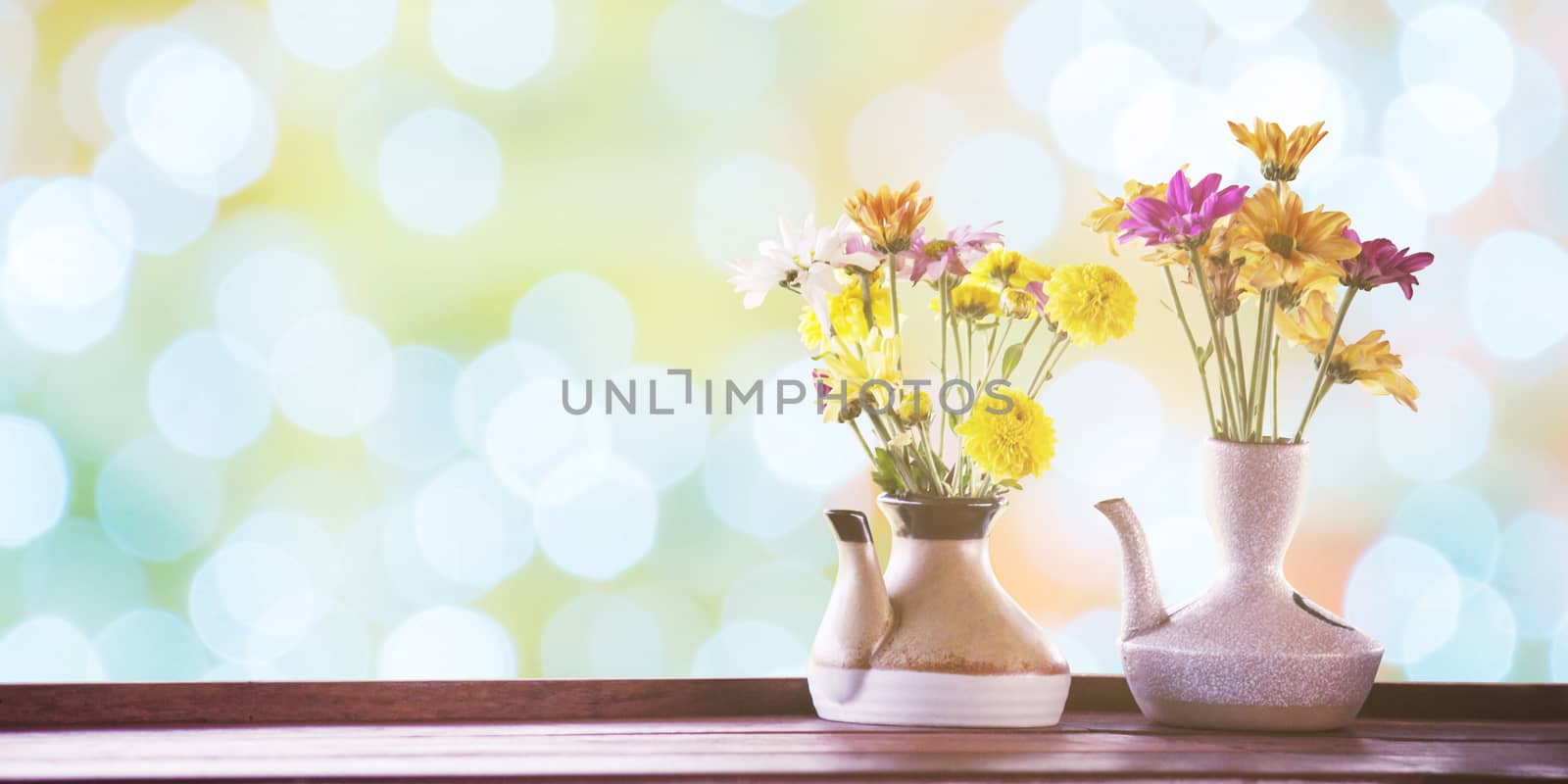vintage photo of flowers in ceramic potted on bokeh for backgrou by rakoptonLPN
