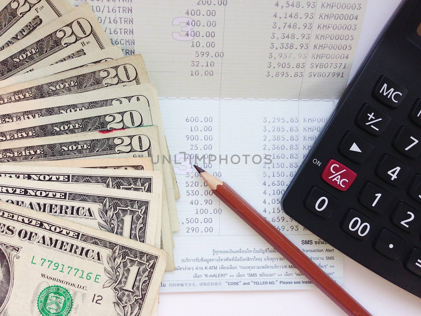 Business, finance, investment, money exchange or accounting concept : American Dollar cash money, calculator and saving account book or financial statement on office table