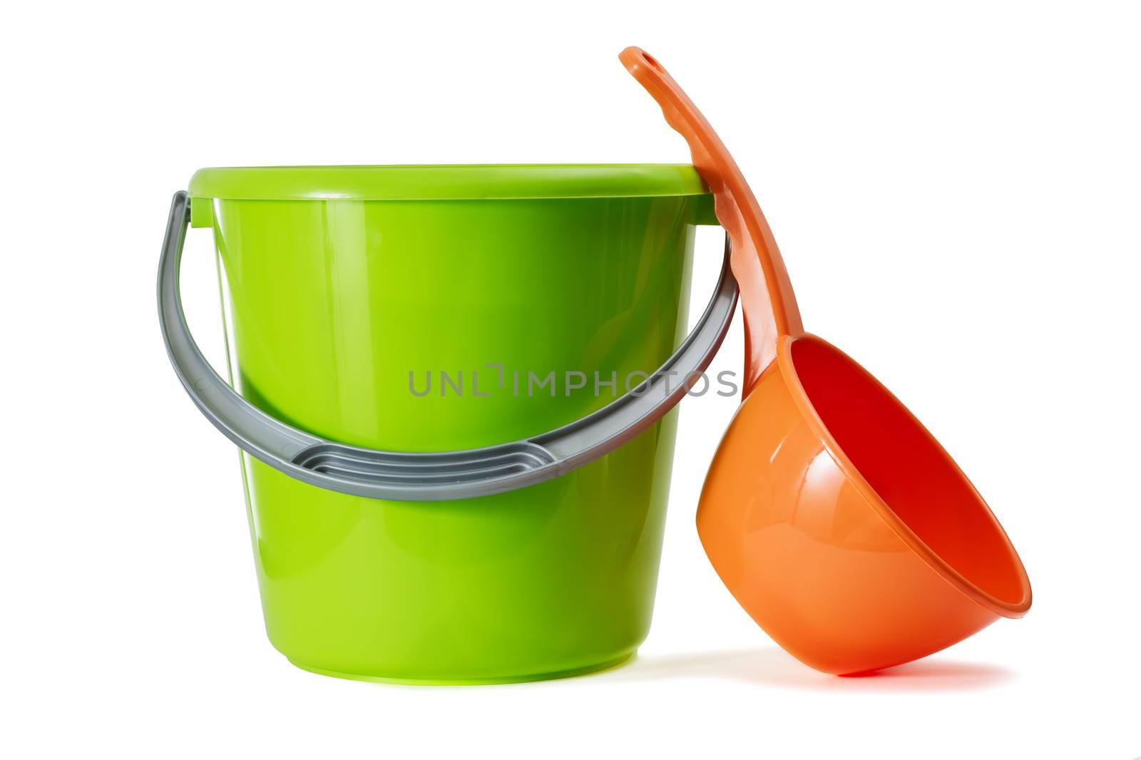 The green plastic bucket and red ladle is isolated on a white background