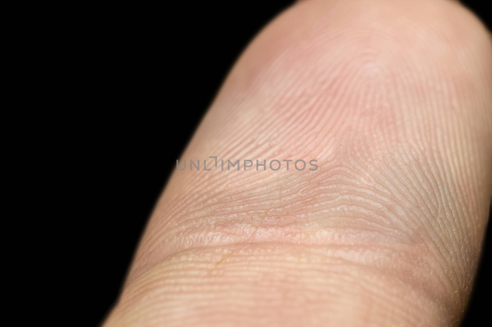 Close-up of fingerprint on index finger isolated on black backgr by Milovan