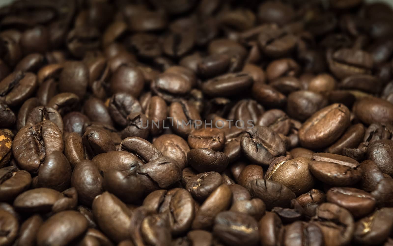 Closeup view of brown coffee beans texture by Milovan