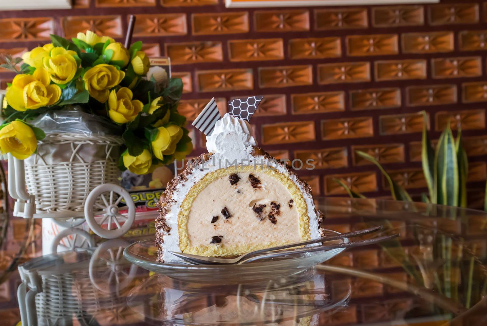 Cake icecream on glass plate with brick wall background