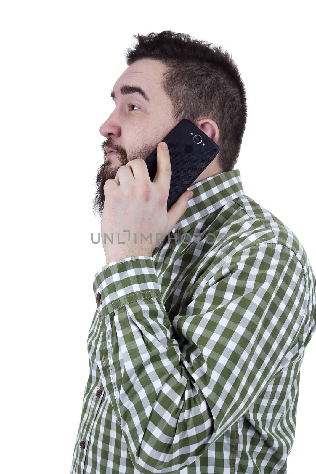 Young man with a beard speaks on a mobile phone
