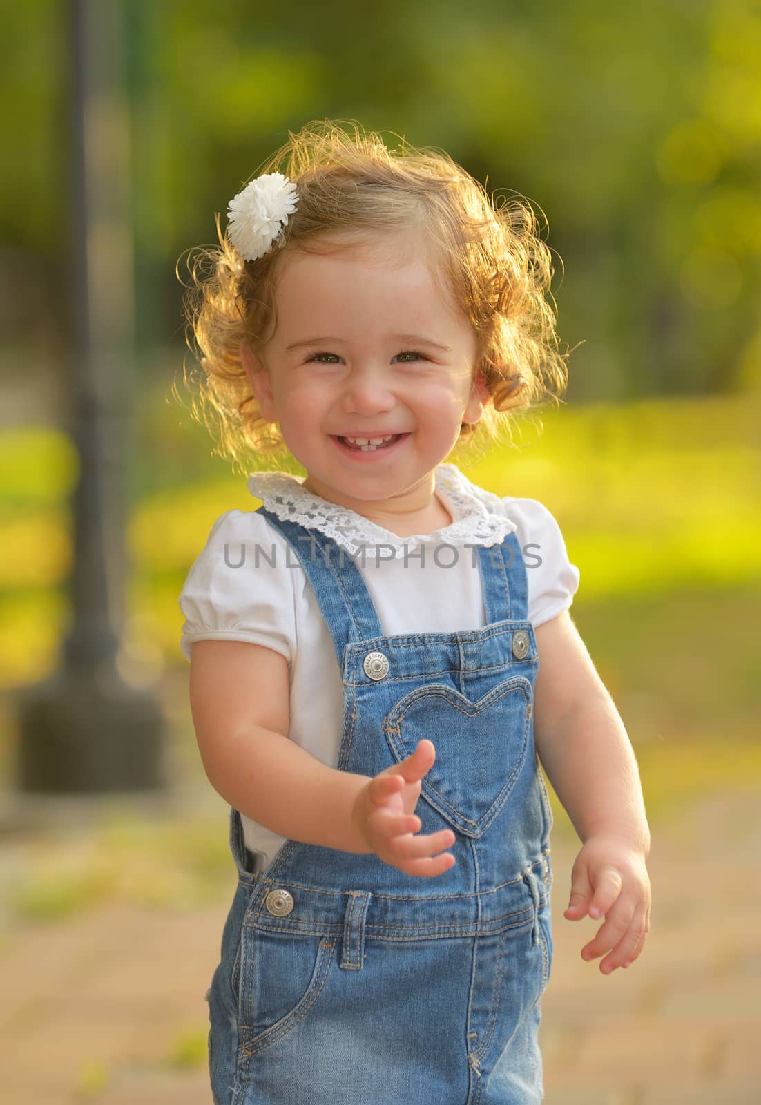 Little girl smiling against the sun