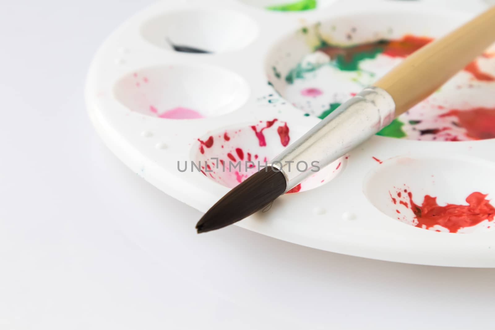 Closeup Paintbrush and Palette with watercolor, artist concept