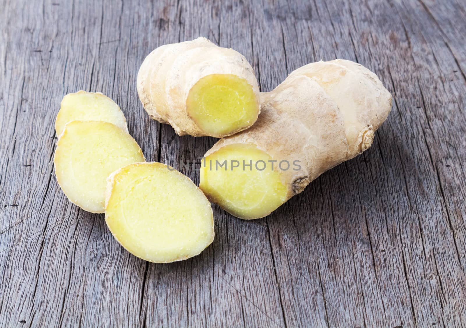 Fresh ginger on old wood background, raw material for cooking