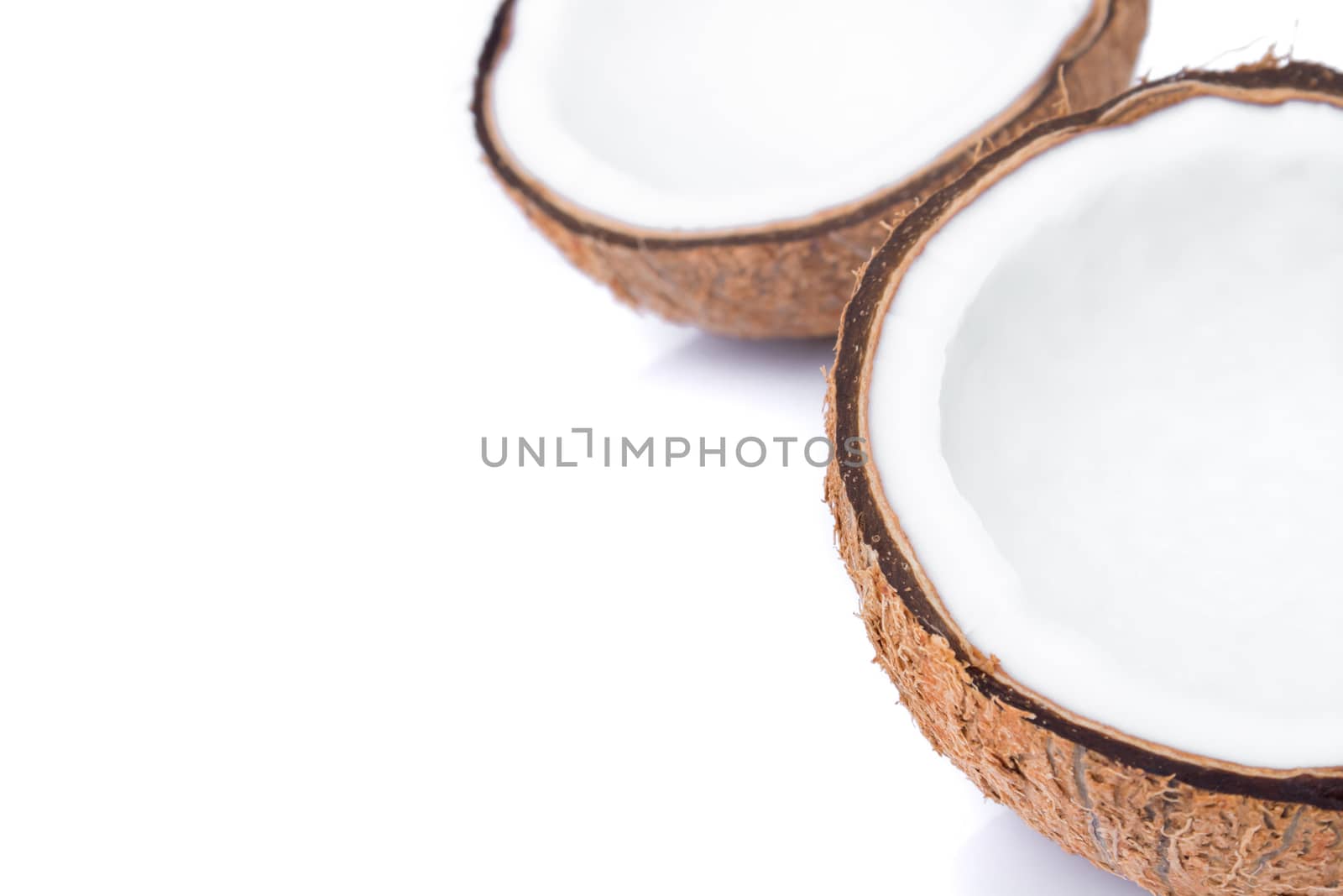 Closeup half of brown coconut shell on white background