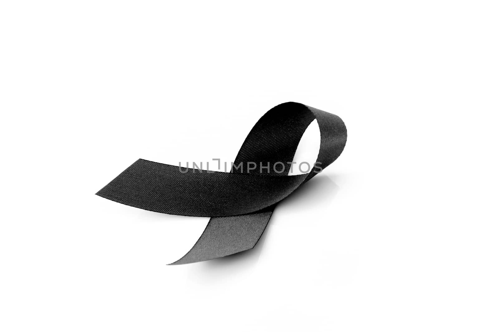 Black ribbon symbol for mourning on white background