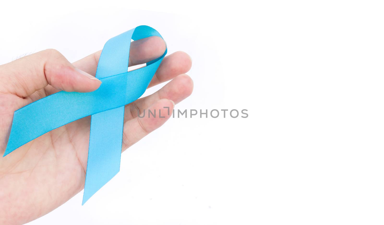Hand hold blue ribbon on white background prostate cancer awareness concept
