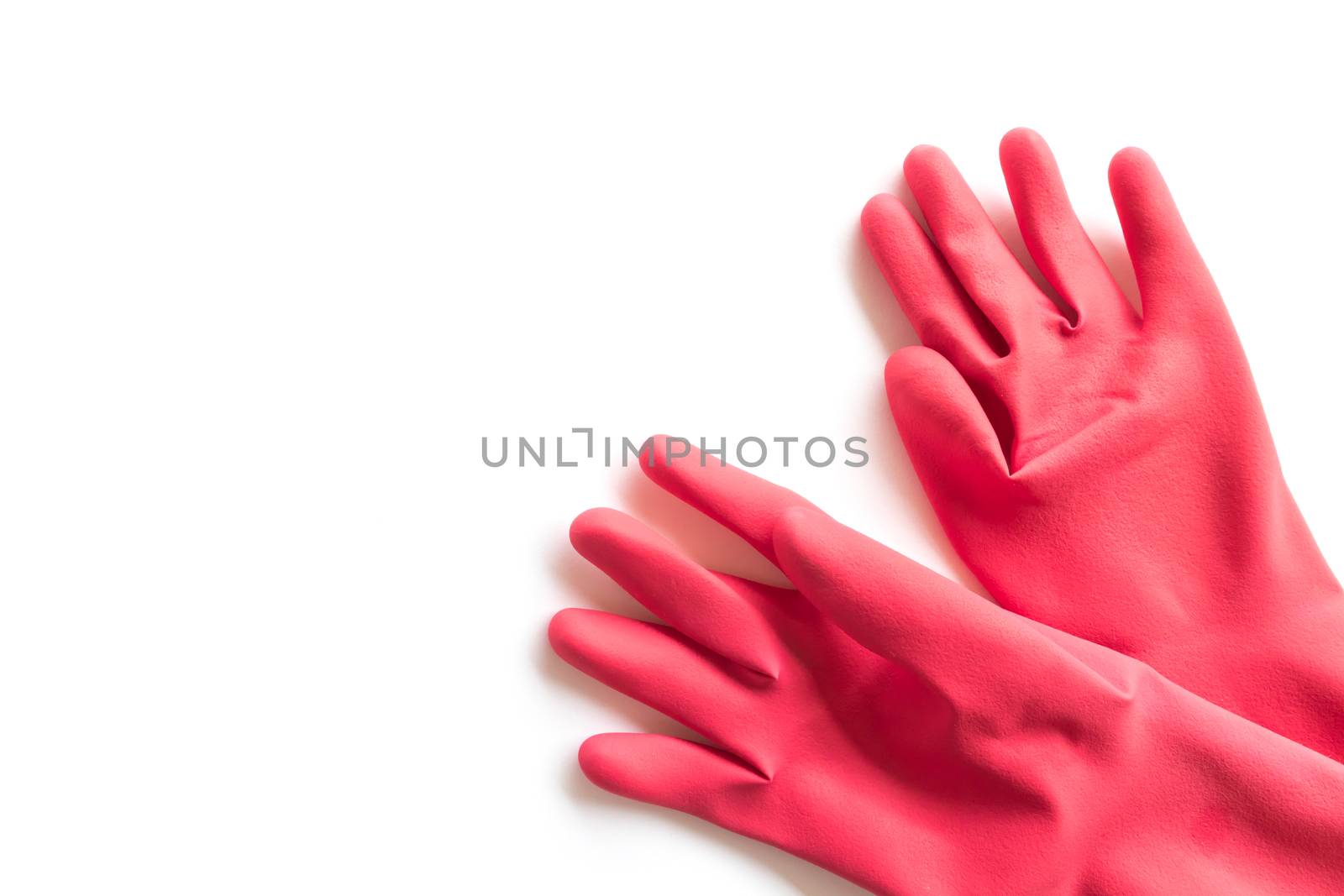Closeup Red rubber gloves for cleaning on white background, workhouse concept