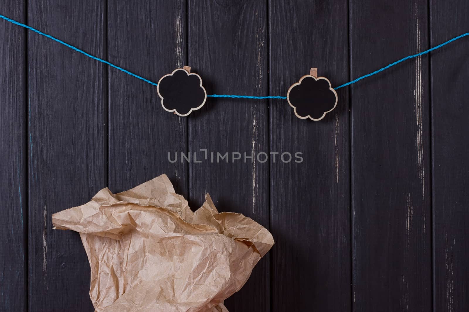 A craft bag near a black fence with a clothes peg and a place for text