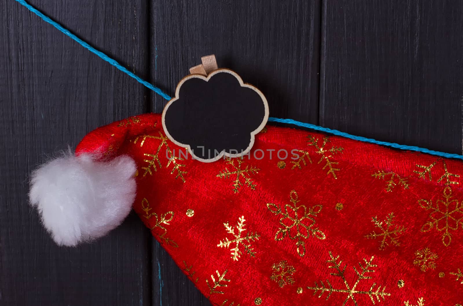 Santa Claus caps hang on a rope, an inscription Christmas