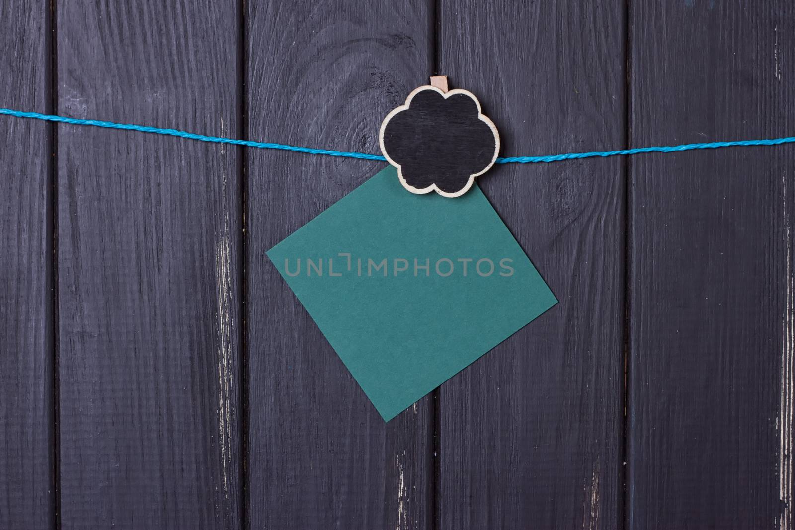 Clothespins with space for text on a black wooden fence