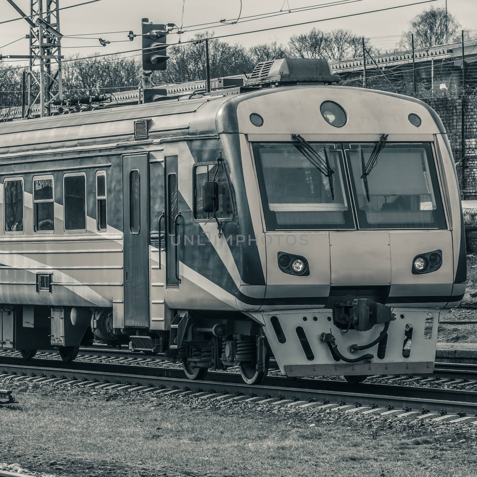 Modern passenger electric train moving at the old terminal