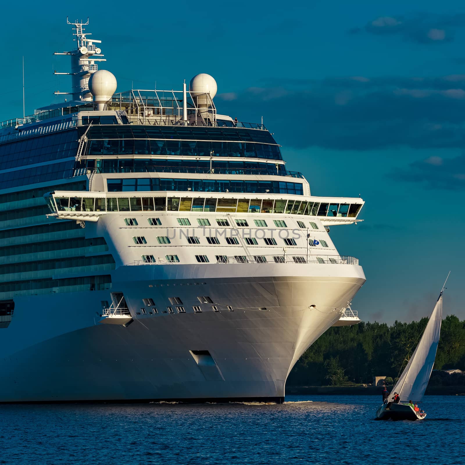 White giant brand new passenger ship moving in clear summer day