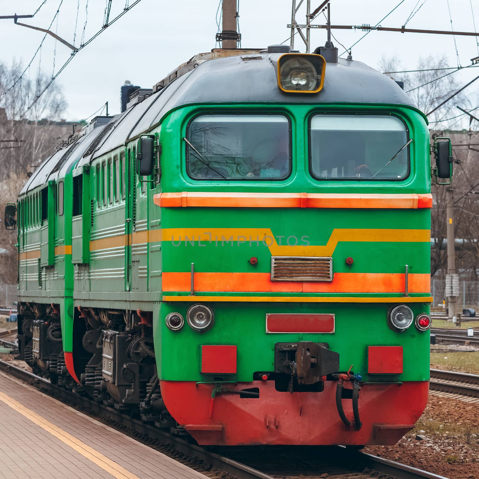 Green diesel cargo locomotive. Freight train in action