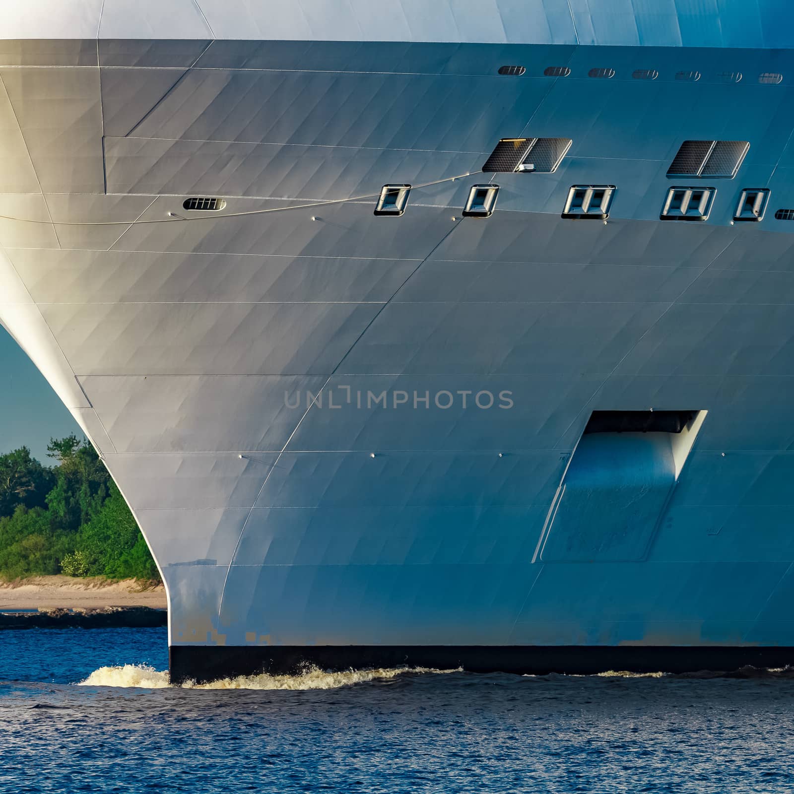 White giant brand new passenger ship moving in clear summer day