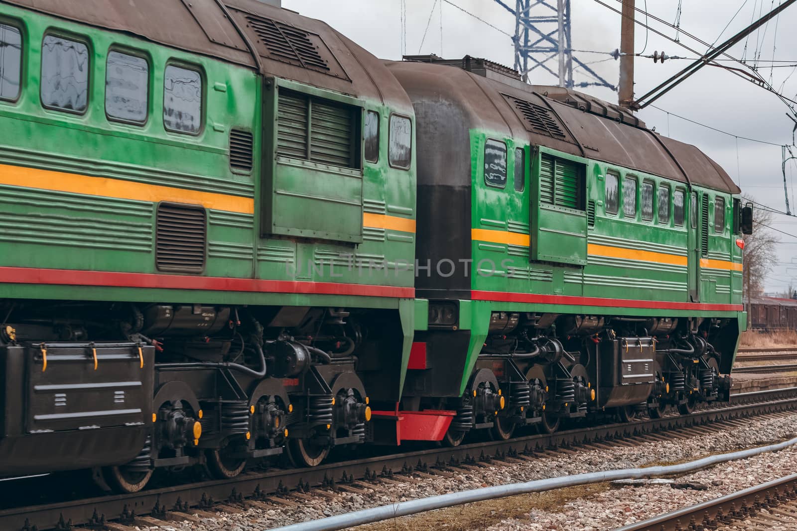 Green diesel cargo locomotive. Freight train in action