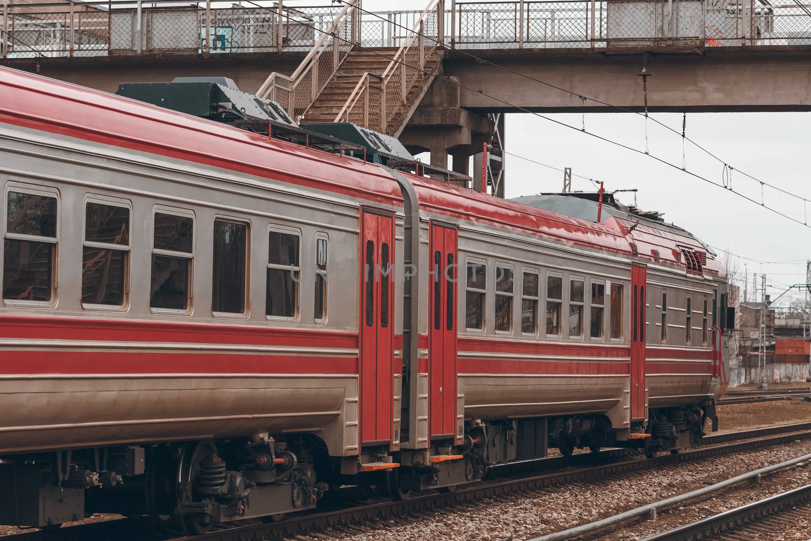 Red diesel passenger train driving at the old terminal