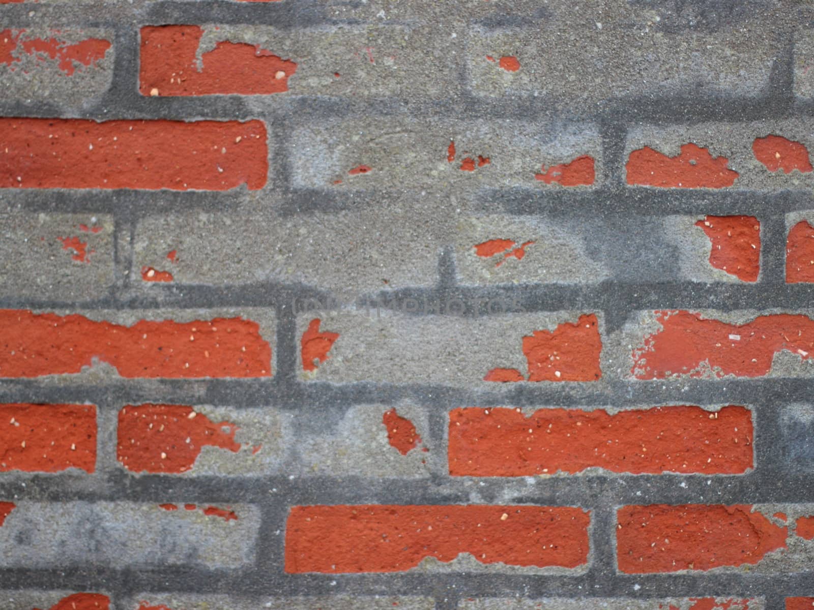 Red Worn Repaired Brickwall with Uneven Mortar Closeup