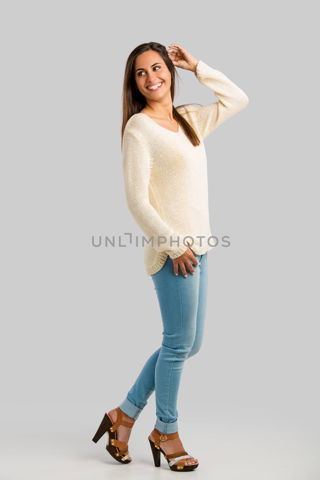 Full length studio shot of a young woman smiling