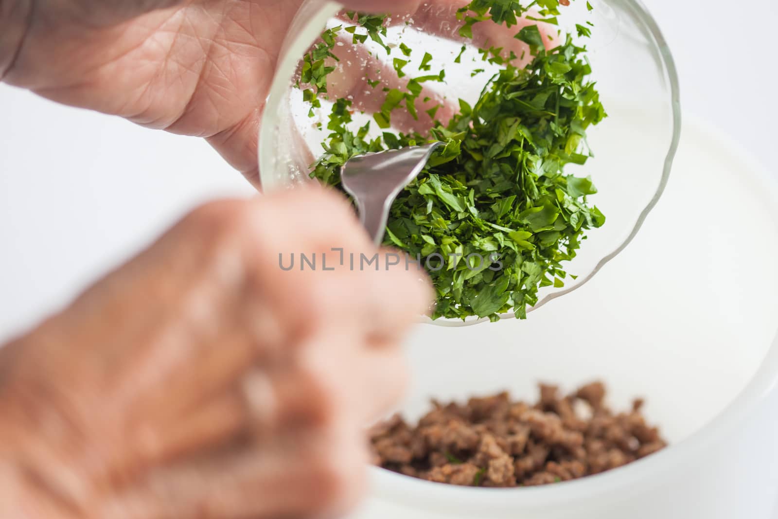Step by step Levantine cuisine kibbeh preparation : Mixing the ingredients to prepare kibbeh filling into a bowl
