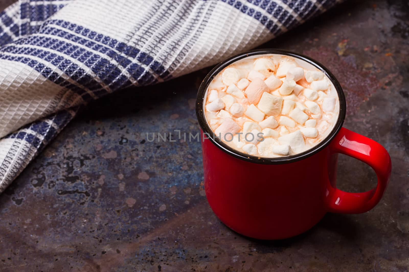 Hot chocolate with marshmallows on grunge dark table