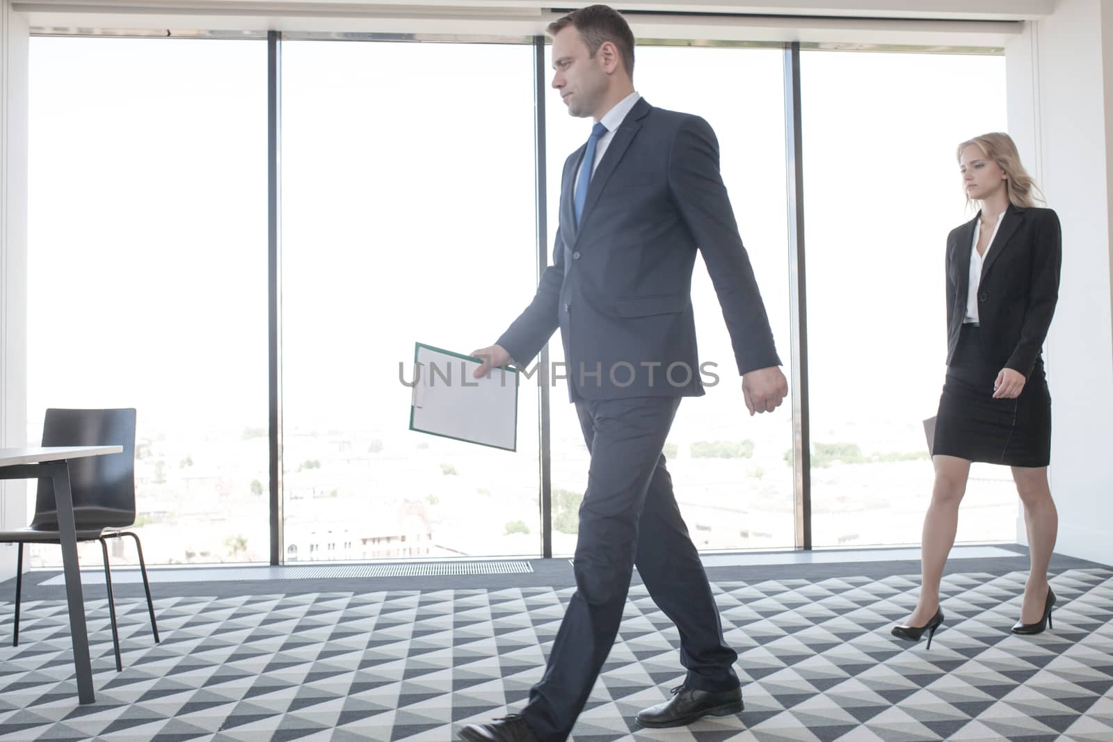 Business speaker and business woman coming to conference room