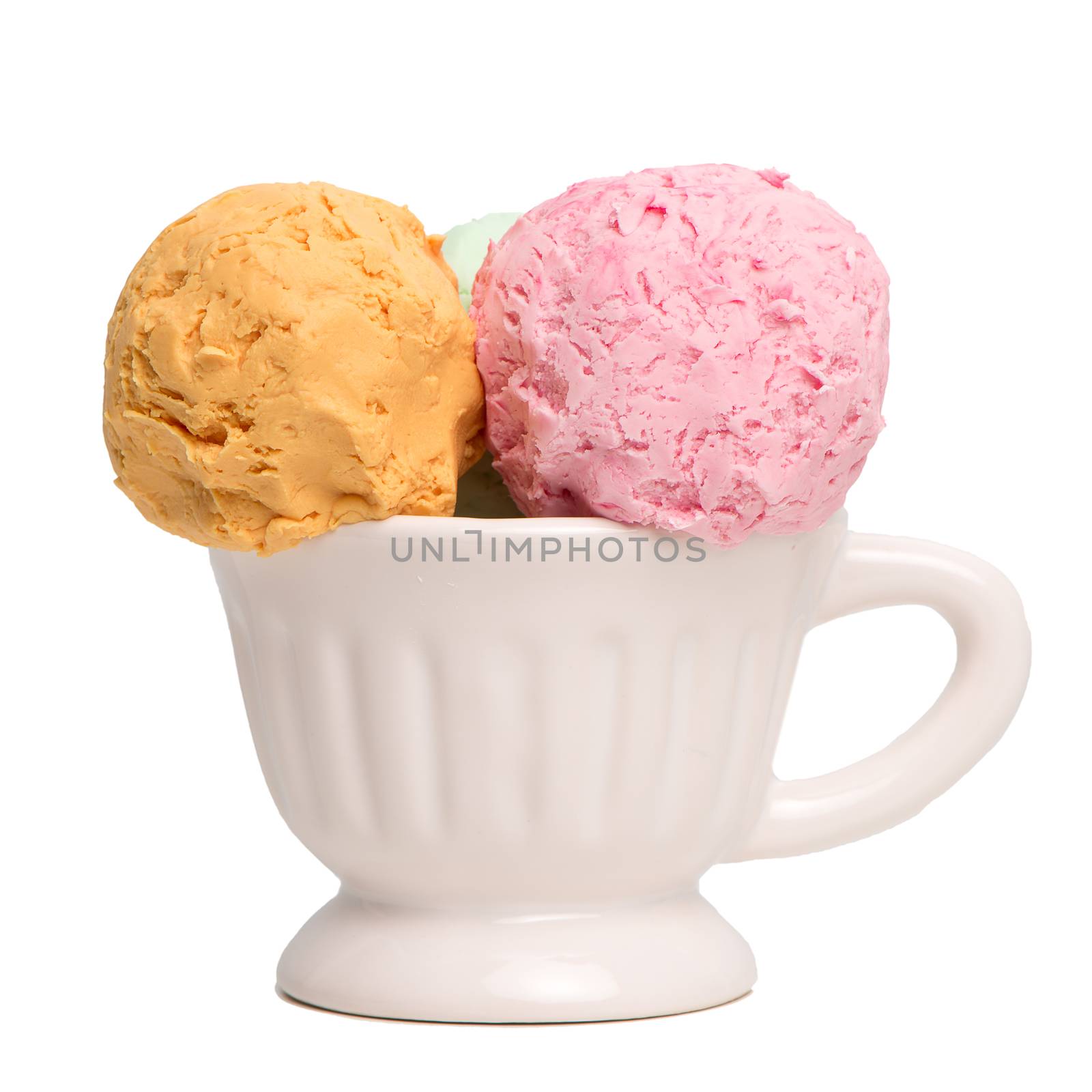 Ceramic bowl of various colorful ice cream balls isolated on white background. From side view.