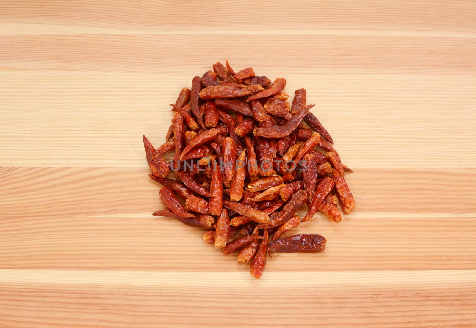 Birds eye chillis on a wooden background, pine wood grain