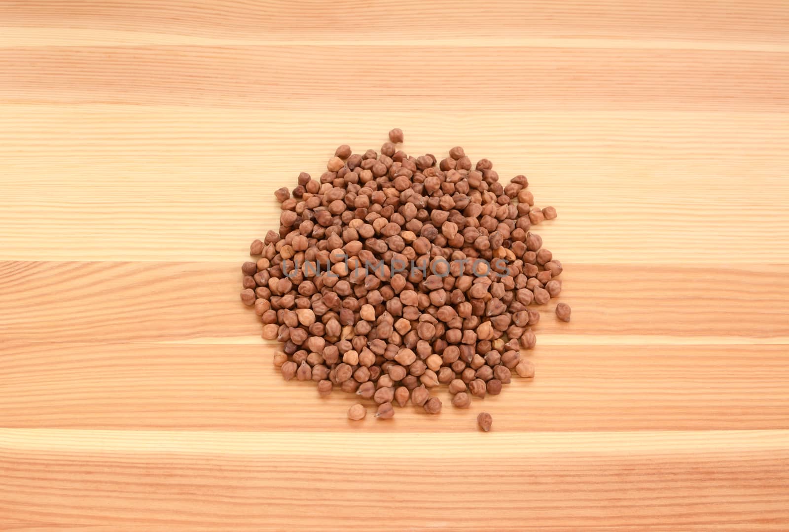 Black chickpeas on a wooden background, pine wood grain