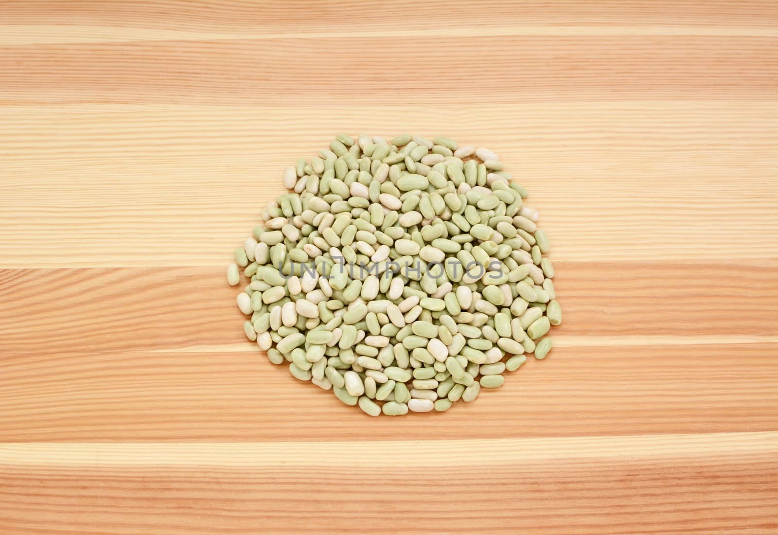 Flageolet beans on a wooden background, pine wood grain
