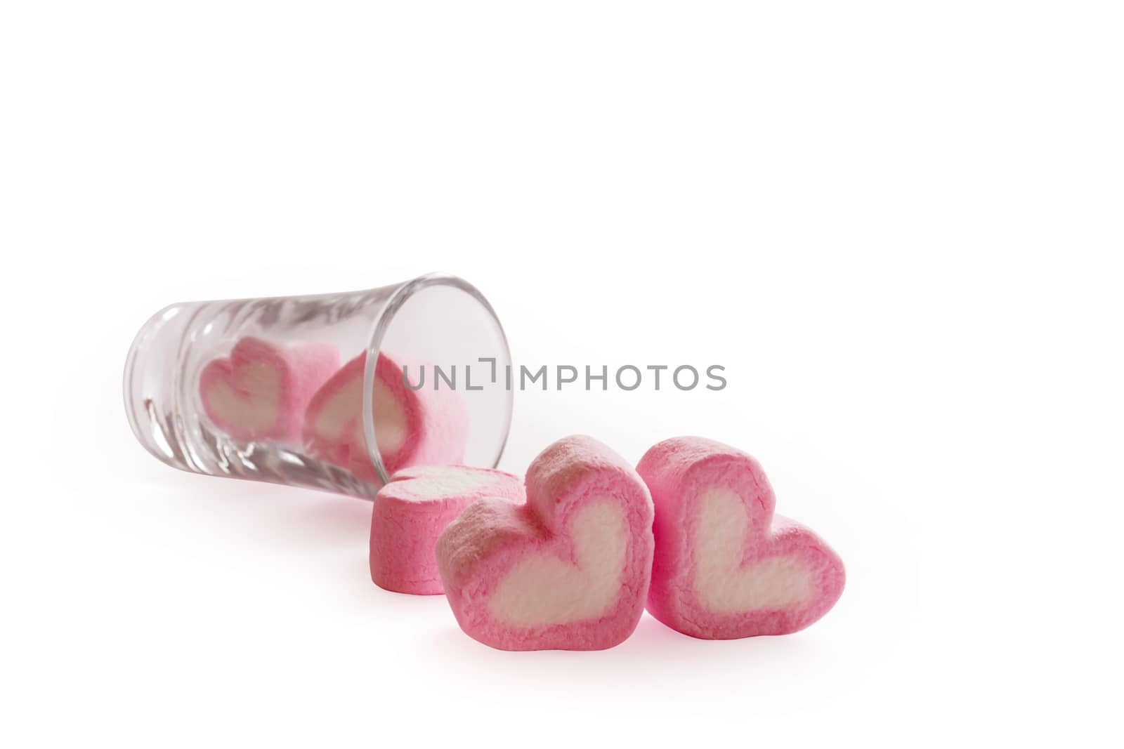 Marshmallow pink heart shape in glass on white background