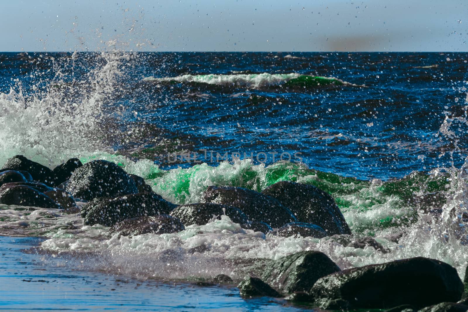 Summer ocean beach with green waves at sunny day