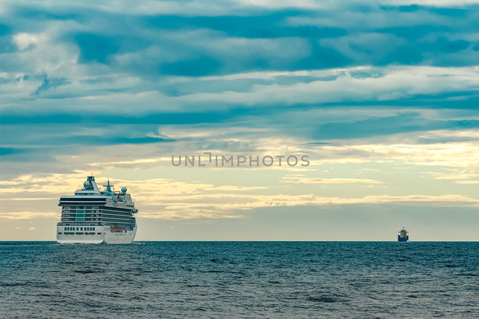 White cruise liner moving to the sea at cloudy day