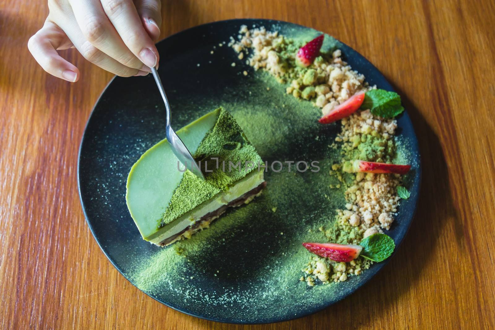 Matcha green tea ice cream cake with strawberry and cookie crumble