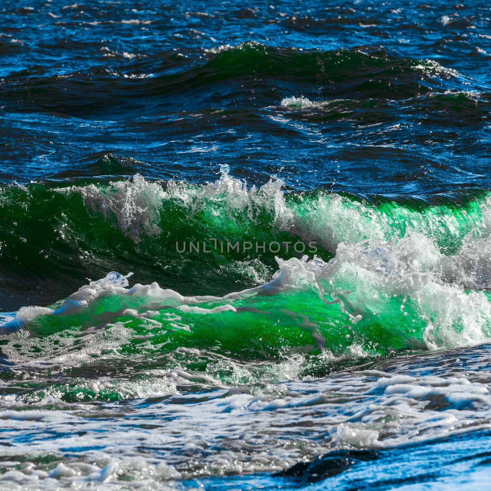Summer ocean beach with green waves at sunny day