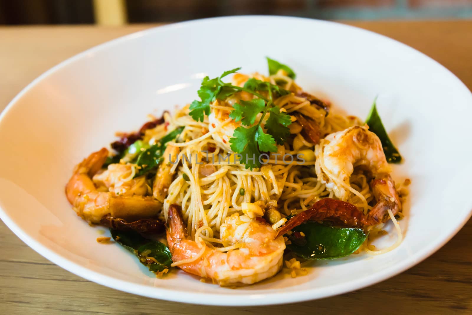 Spicy stir fried spaghetti seafood on white dish