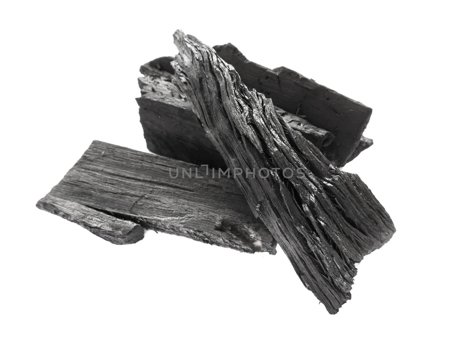 Closeup black charcoal on white background, raw material for make cooking