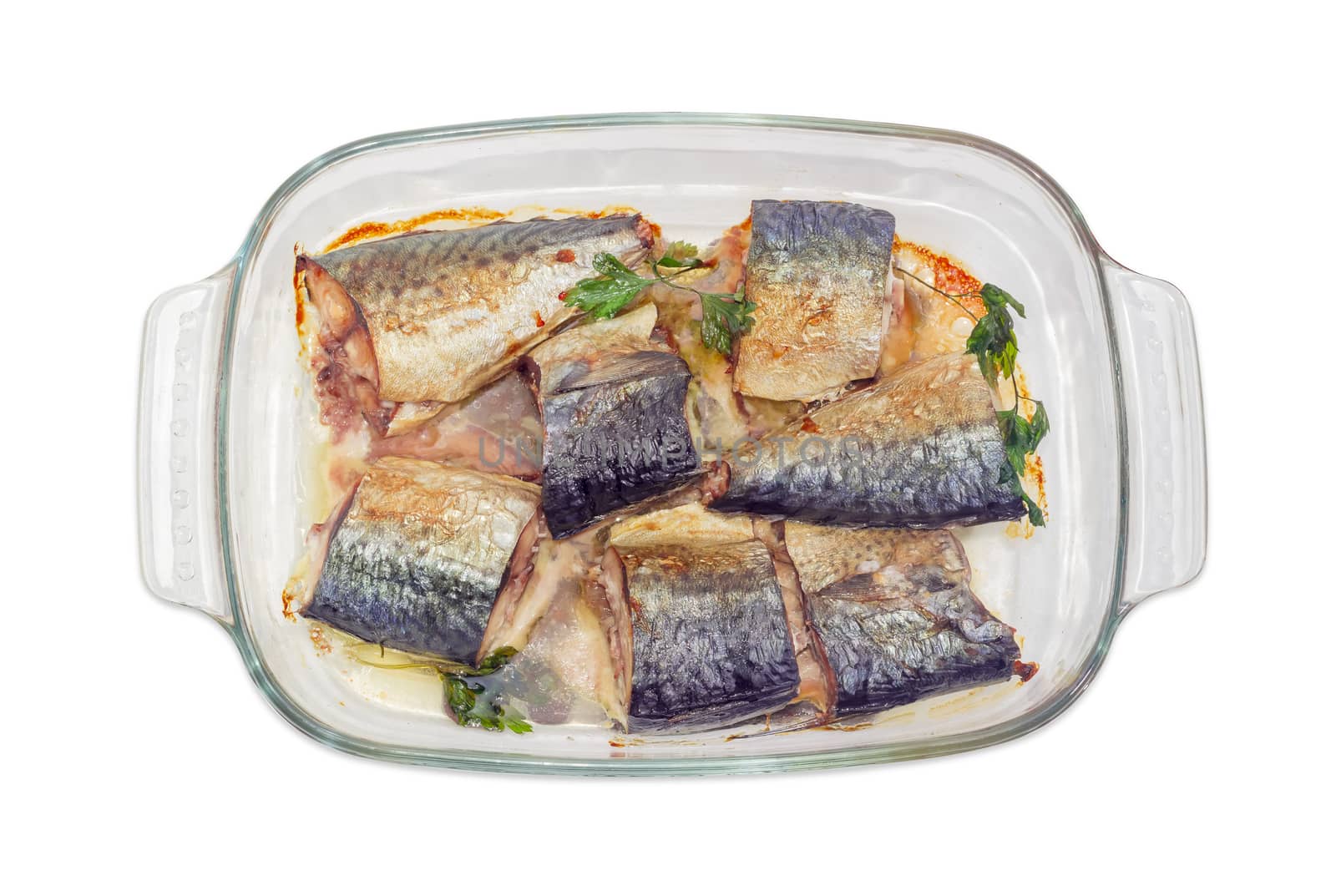 Top view of the rectangular glass pan for baking with baked pieces of Atlantic chub mackerel on a white background
