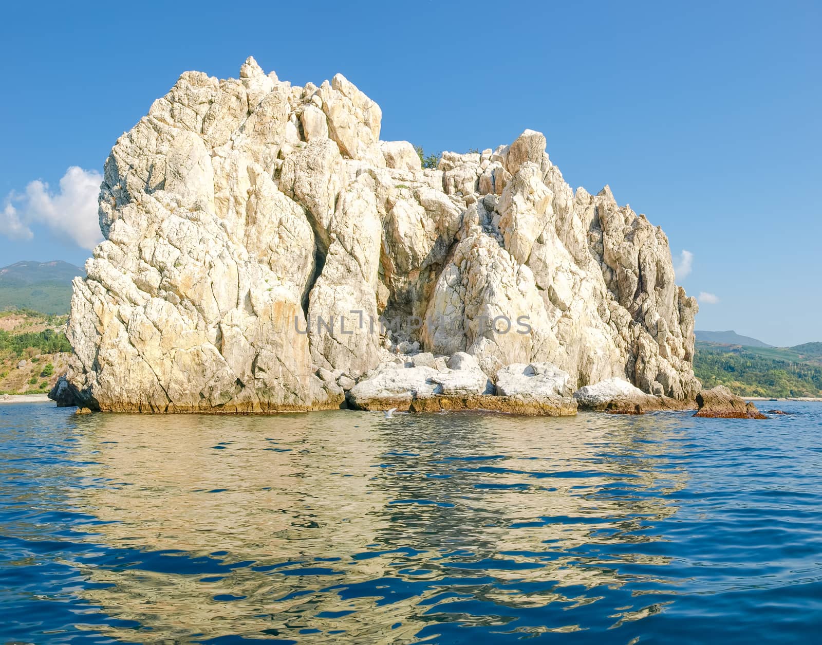 Single limestone rock in the sea near the shore by anmbph