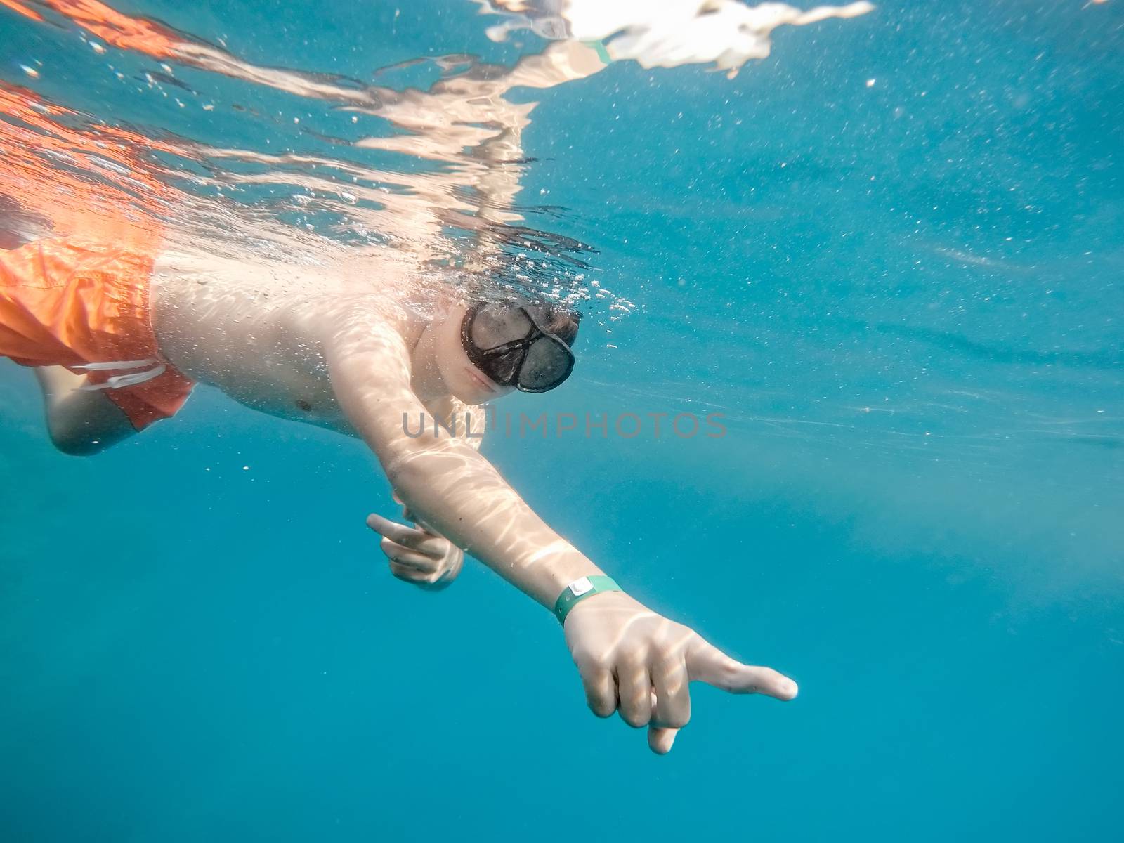 Young boy snorkel swim in underwater exotic tropics paradise with fish and coral reef. Marsa alam, Egypt. Summer holiday  vacation concept