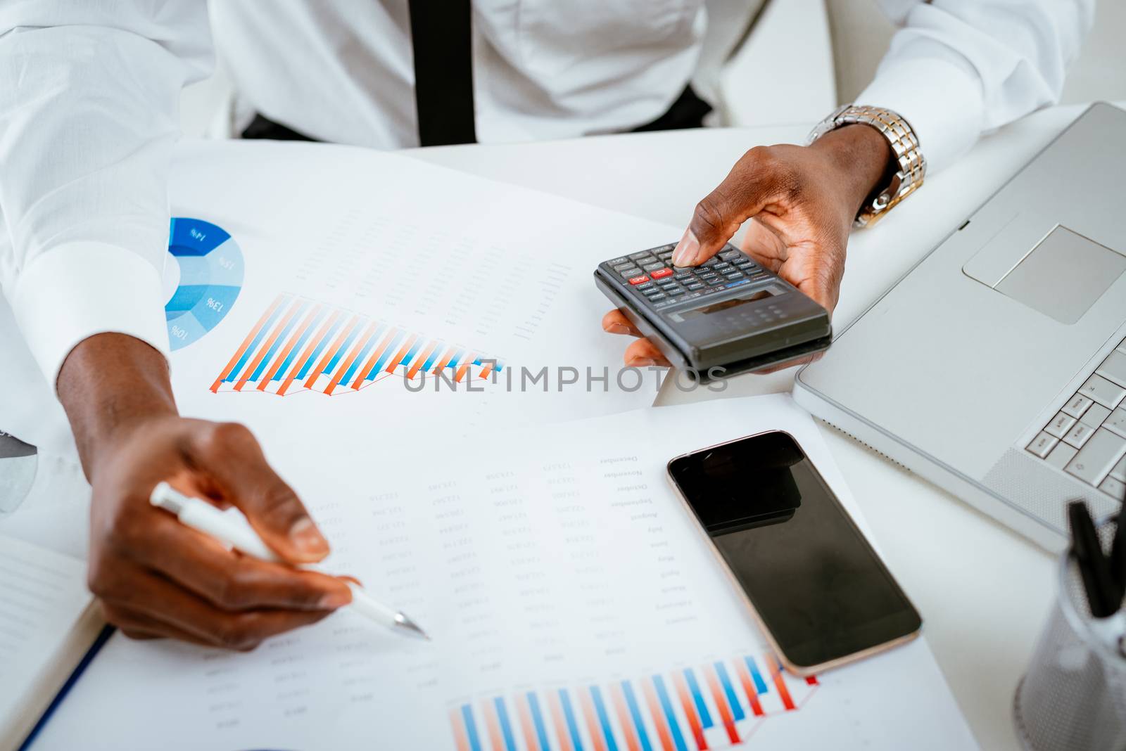 African Man Using Calculator by MilanMarkovic78